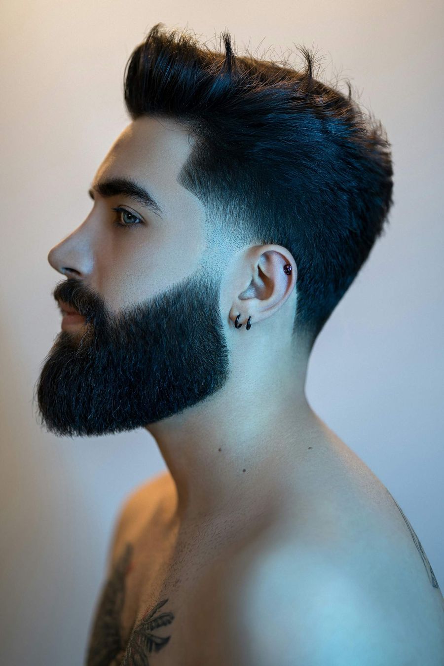 Side profile of a skin fade with a shaped full beard